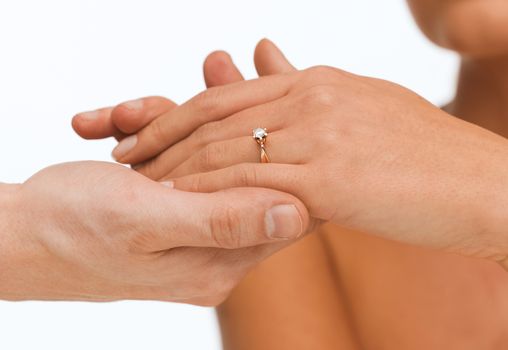 bridal, couple, jewellery, wedding, luxury concept - man puts wedding ring on woman hand