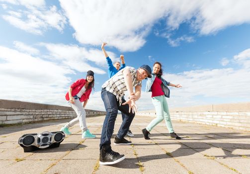 sport, dancing and urban culture concept - group of teenagers dancing