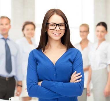 office, buisness, teamwork concept - friendly young smiling businesswoman