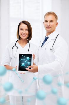 healthcare, hospital, research, science and medical concept - two doctors showing tablet pc with molecules