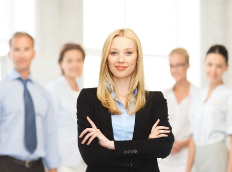 office, buisness, teamwork concept - friendly young smiling businesswoman