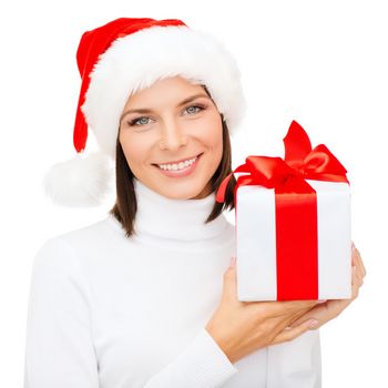 christmas, x-mas, winter, happiness concept - smiling woman in santa helper hat with gift box