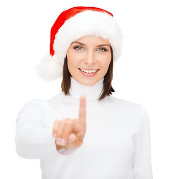 christmas, x-mas, winter, happiness concept - smiling woman in santa helper hat pressing vitrual button