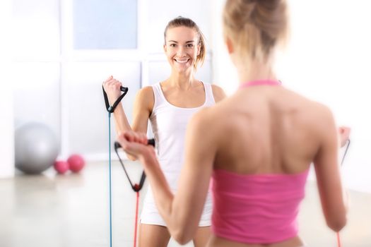 Beautiful, young, slim, athletic woman during a workout at the gym