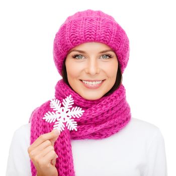 winter, people, happiness concept - woman in hat and muffler with big snowflake