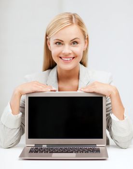 education,business, technology and internet concept - smiling woman with laptop pc