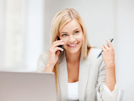 business and education concept - picture of businesswoman with laptop and cell phone