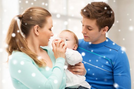 children, christmas, x-mas, love concept - happy family and adorable baby with feeding-bottle