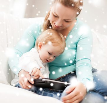 family, children, christmas, x-mas, love, technology concept - happy mother and adorable baby with tablet pc