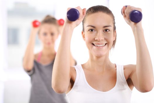 Beautiful, young, slim, athletic woman during a workout at the gym