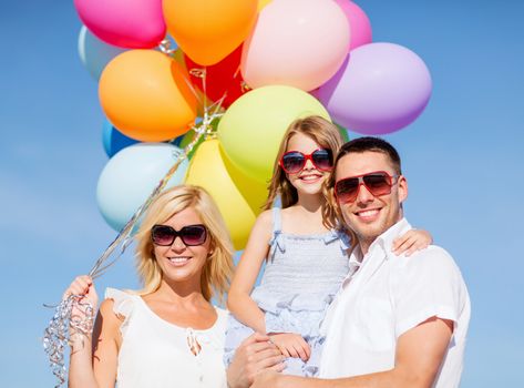 summer holidays, celebration, children and people concept - family with colorful balloons