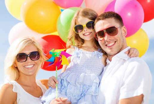 summer holidays, celebration, children and people concept - family with colorful balloons