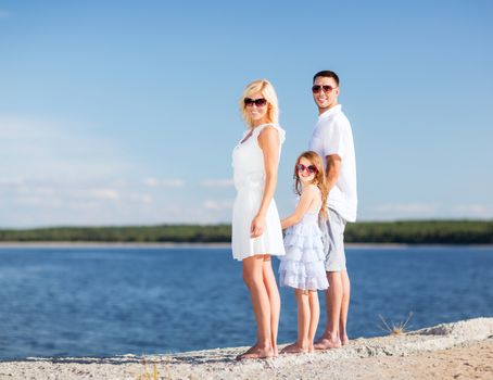 summer holidays, children and people concept - happy family with blue sky