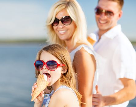 summer holidays, celebration, children and people concept - happy family eating ice cream