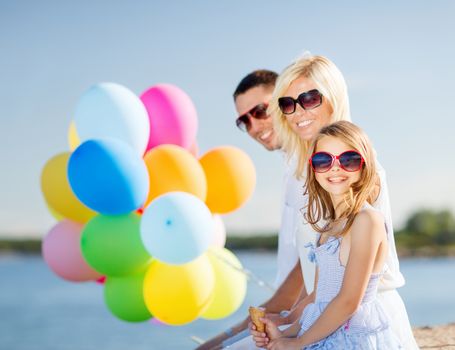 summer holidays, celebration, children and people concept - family with colorful balloons