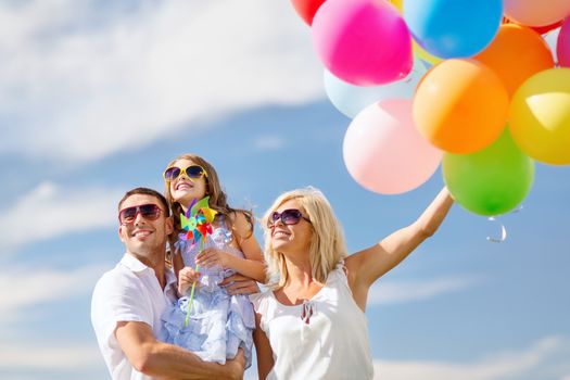 summer holidays, celebration, children and people concept - family with colorful balloons