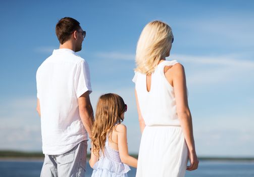 summer holidays, celebration, children and people concept - happy family at the seaside