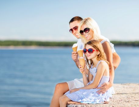 summer holidays, celebration, children and people concept - happy family eating ice cream