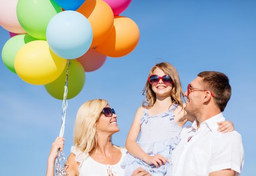 summer holidays, celebration, children and people concept - family with colorful balloons