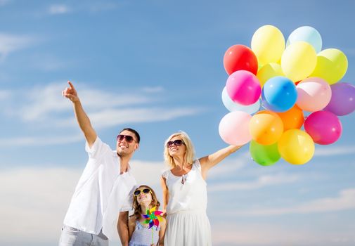 summer holidays, celebration, children and people concept - family with colorful balloons