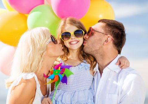 summer holidays, celebration, children and people concept - family with colorful balloons