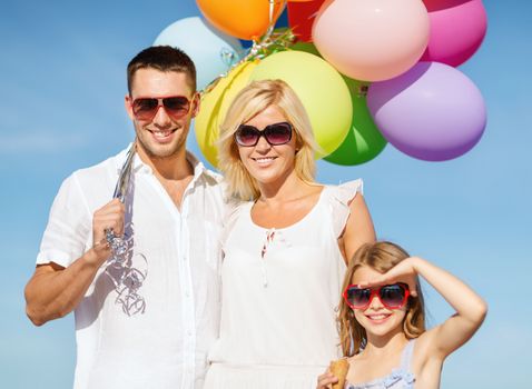 summer holidays, celebration, children and people concept - family with colorful balloons