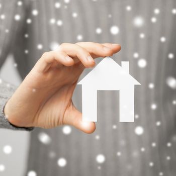 bright picture of man holding paper house