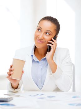 business, and communication concept - smiling african businesswoman with smartphone in office