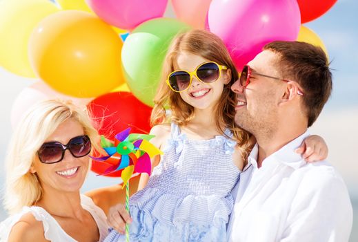 summer holidays, celebration, children and people concept - family with colorful balloons