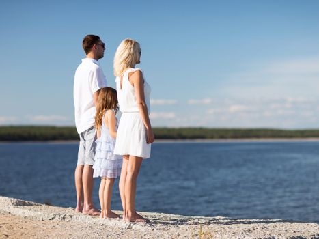 summer holidays, celebration, children and people concept - happy family at the seaside