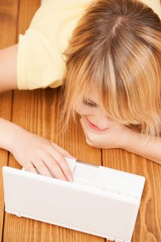 education and internet concept - smiling student girl with laptop at home