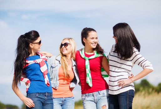 summer, holidays, vacation, happy people concept - beautiful teenage girls or young women having fun on the beach