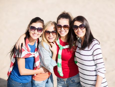 summer, holidays, vacation, happy people concept - beautiful teenage girls or young women having fun on the beach