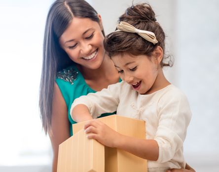 holidays, presents, christmas, x-mas, birthday concept - happy mother and child girl with gift box