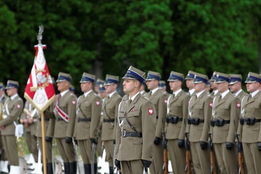 Warsaw, Poland – May 12, 2014: Danish Crown Prince Couple on state visit to Poland. Polish soldiers line up for a parade.