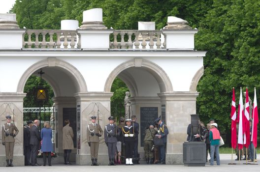 Warsaw, Poland – May 12, 2014: Honor guard at the Tomb of the Unknown Soldier. The monument  is the most important element of the Pilsudski Square and was built-up in a preserved colonnade of the Saxon Palace which was destroyed during the WW II.