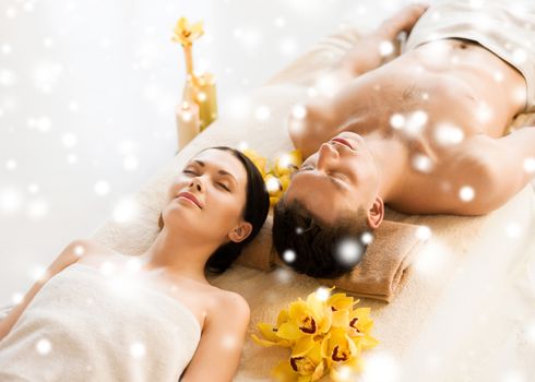 health and beauty concept - couple in spa salon lying on the massage desks