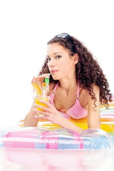 Pretty curl girl drink juice on air mattress, isolated on white
