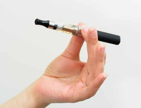 Close up of a woman hand holding an electronic cigarette 