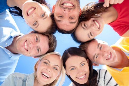 summer, holidays, vacation, happy people concept - group of teenagers looking down