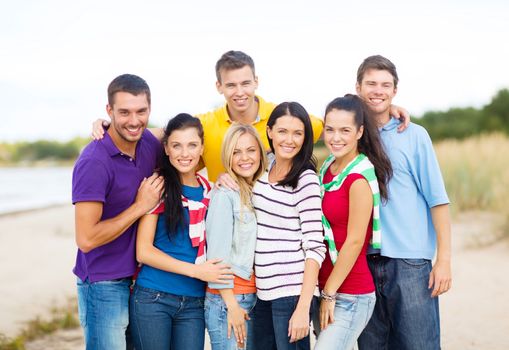 summer, holidays, vacation, happy people concept - group of friends having fun on the beach