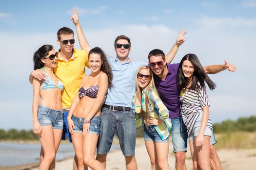 summer, holidays, vacation, happy people concept - group of friends having fun on the beach