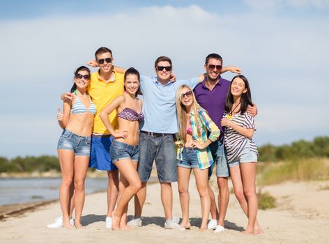 summer, holidays, vacation, happy people concept - group of friends having fun on the beach