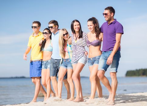 summer, holidays, vacation, happy people concept - group of friends having fun on the beach