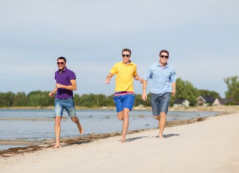 summer, holidays, vacation, happy people concept - group of friends having fun on the beach