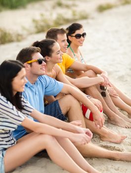 summer, holidays, vacation, happy people concept - group of friends or volleyball team having fun on the beach