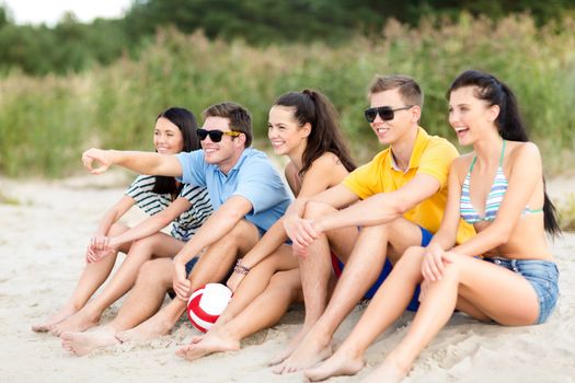 summer, holidays, vacation, happy people concept - group of friends or volleyball team having fun on the beach