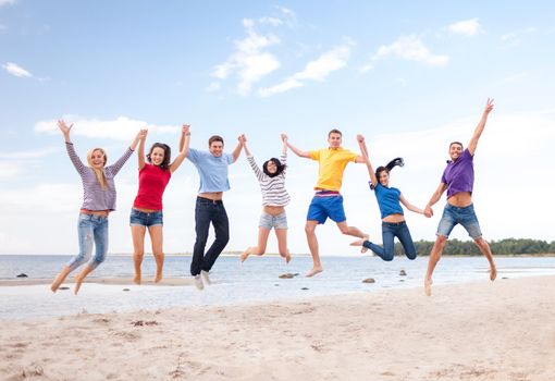 summer, holidays, vacation, happy people concept - group of friends jumping on the beach