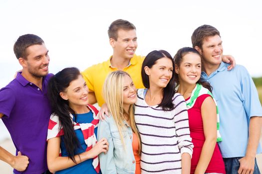 summer, holidays, vacation, happy people concept - group of friends having fun on the beach