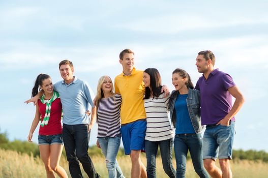 summer, holidays, vacation, happy people concept - group of friends having fun on the beach